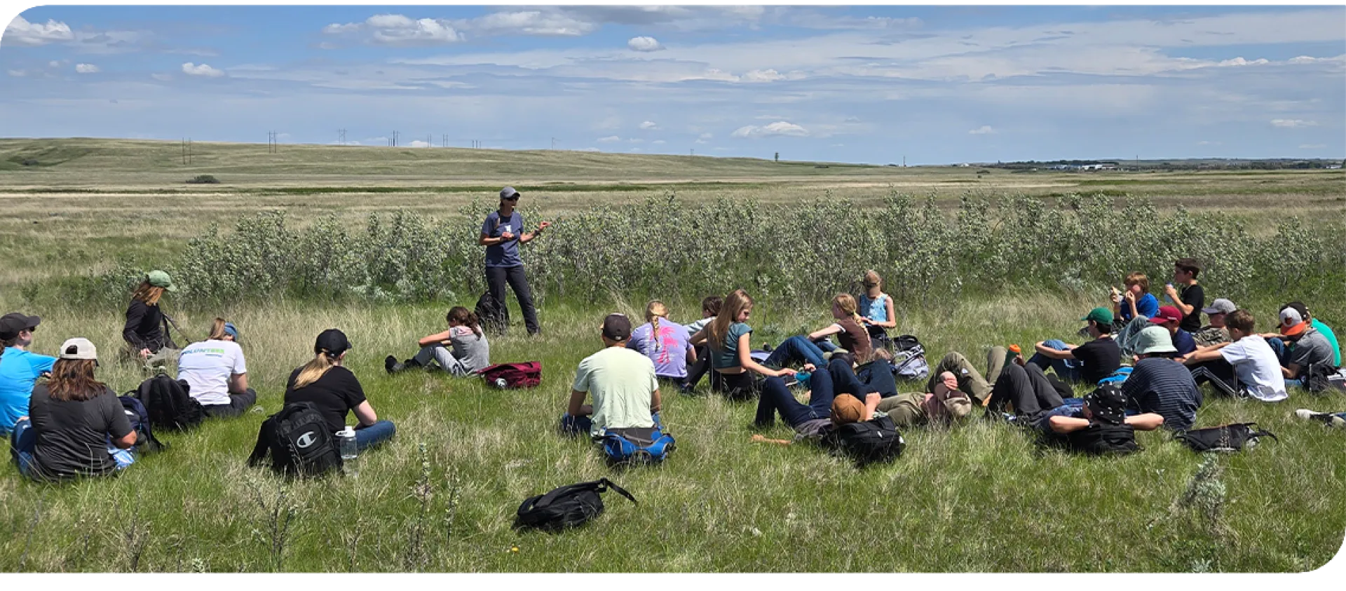 Group sitting in grass.