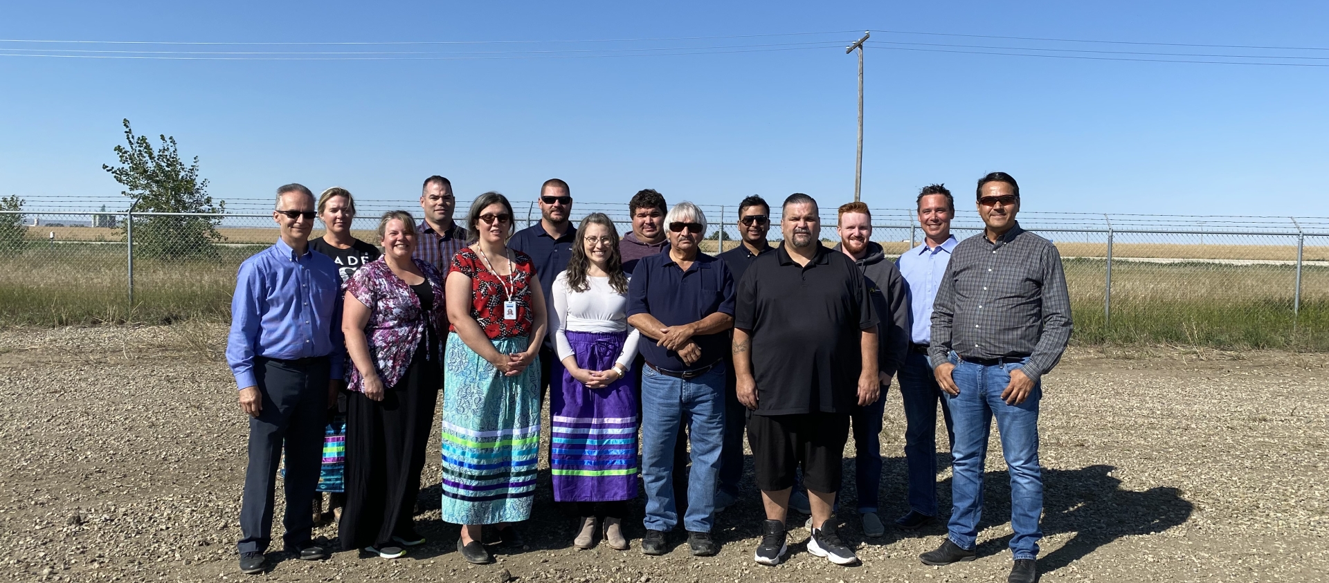 A group of SaskEnergy employees and First Nations members gather for a pipe ceremony.