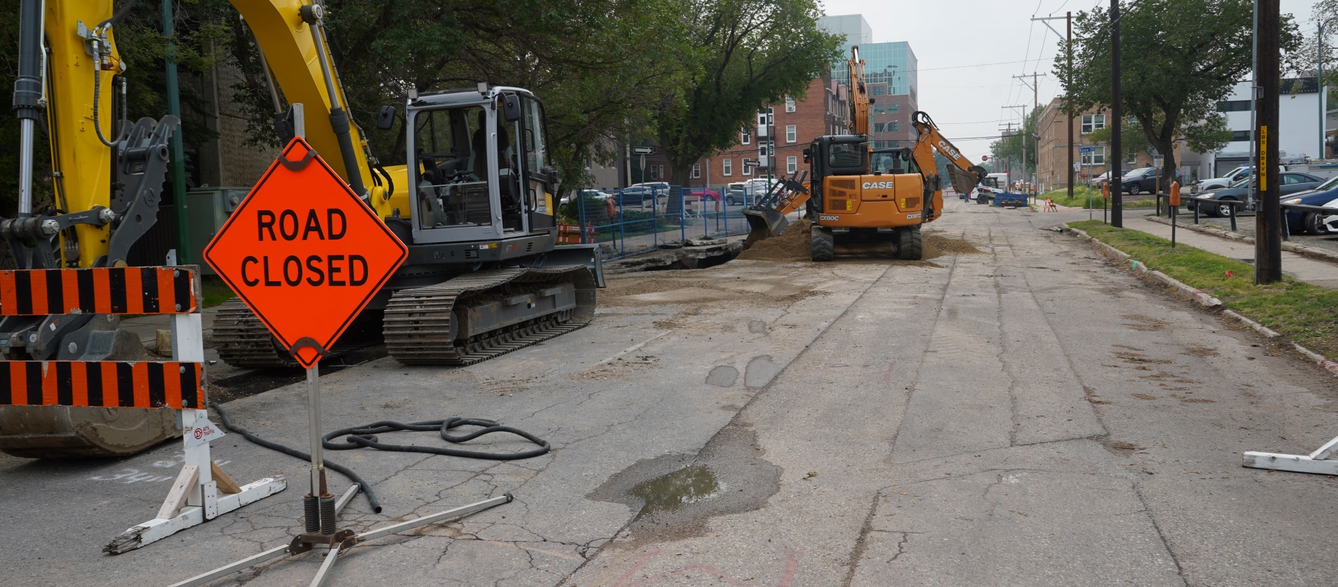 SaskEnergy works to install a new gas line along 13th Avenue in downtown Regina. "Road Closed" sign on a construction site.