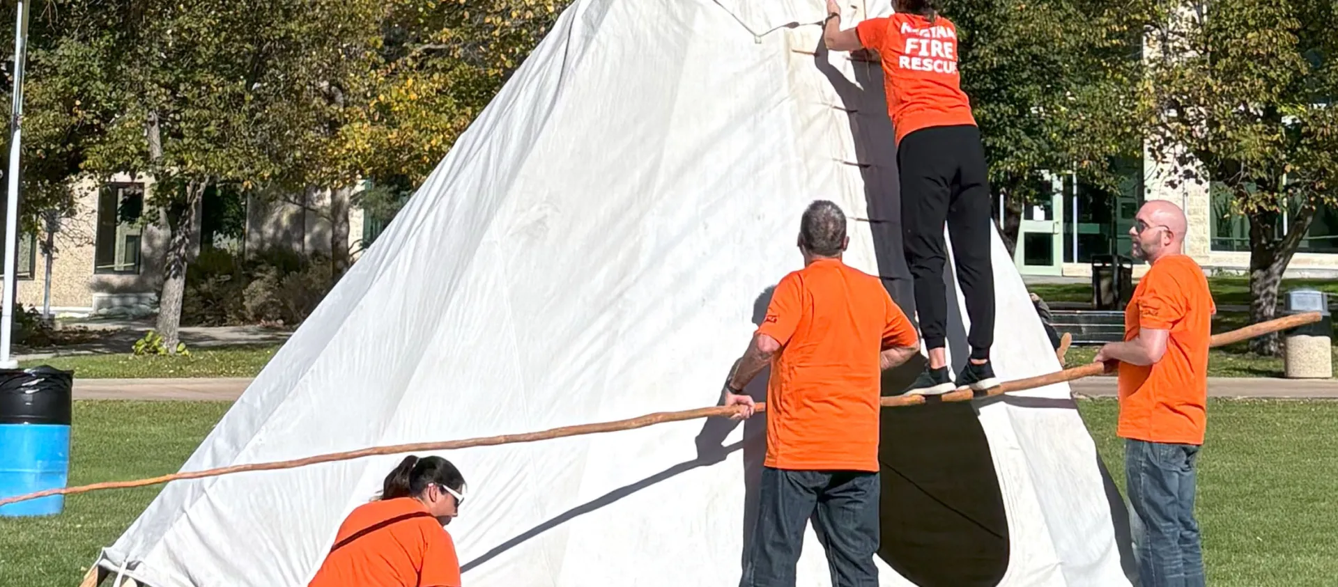 group building a tipi