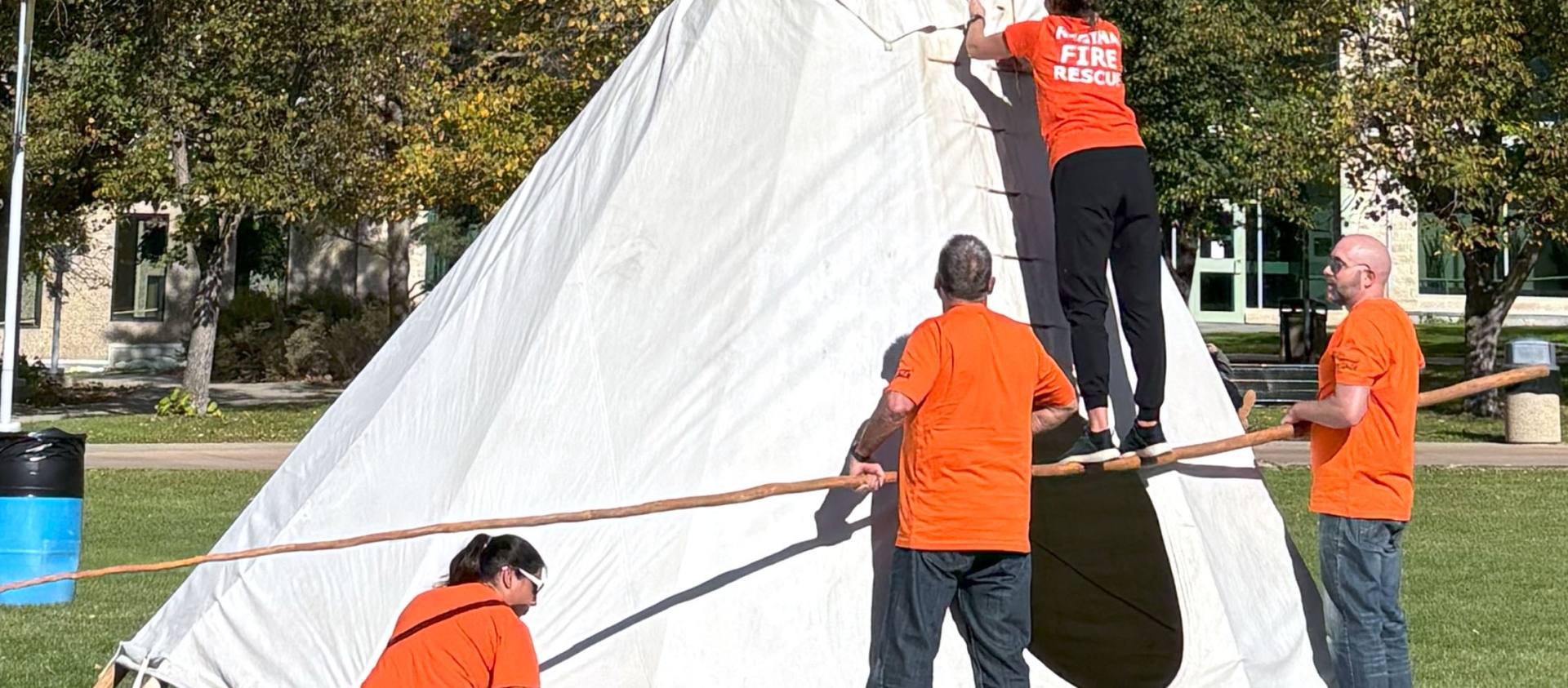 group building a tipi