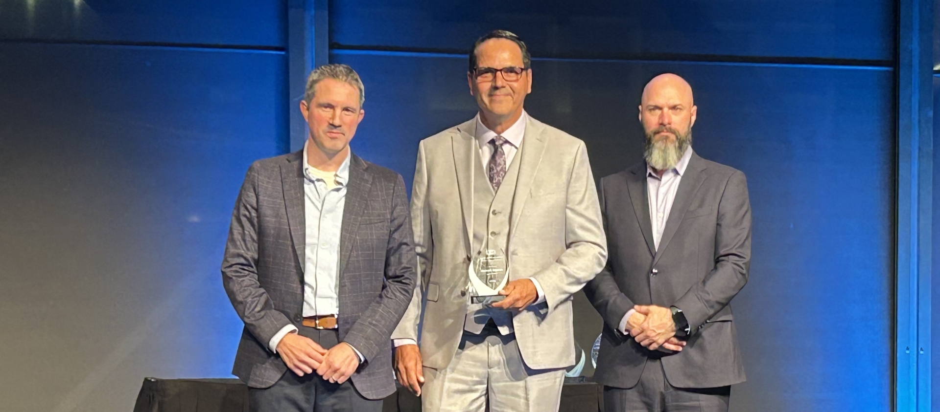 SaskEnergy representative on stage receiving award.