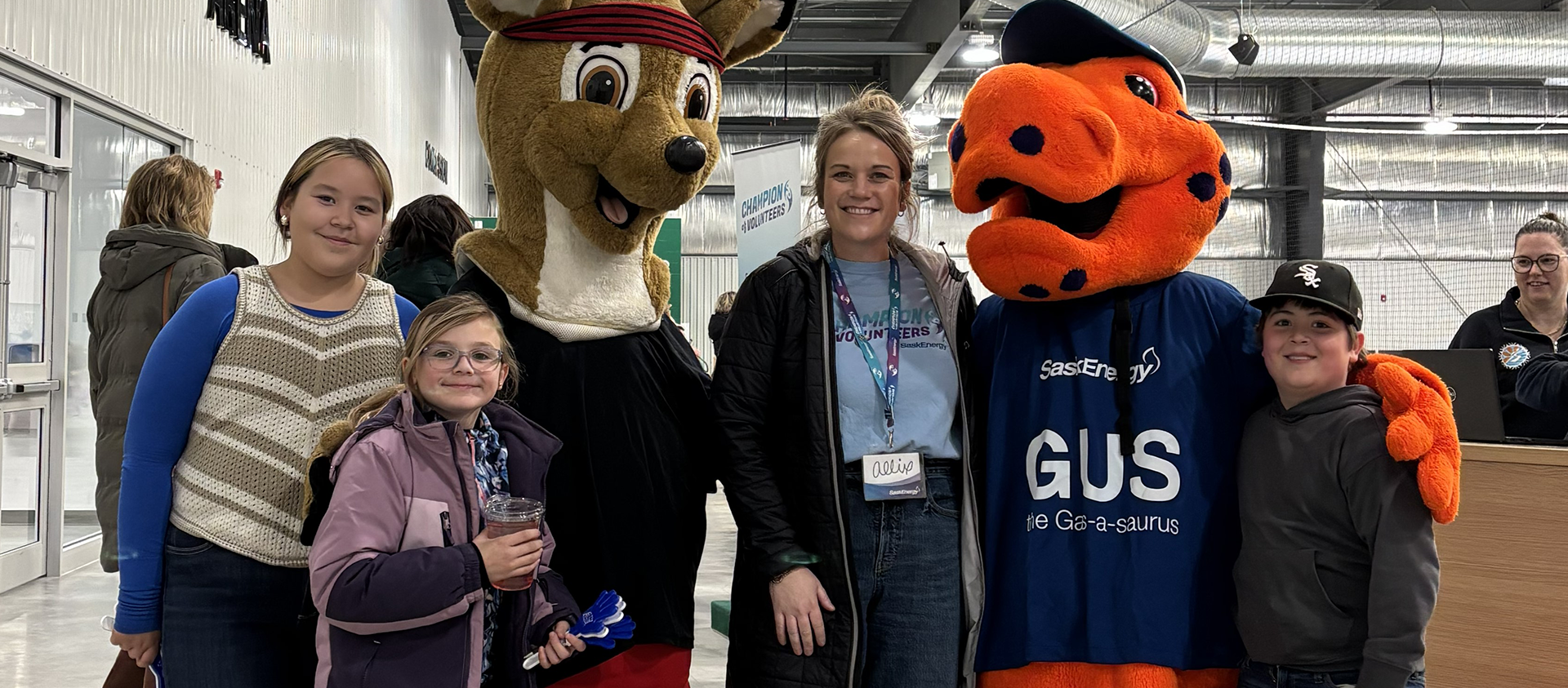 Mascots and people pose for photo