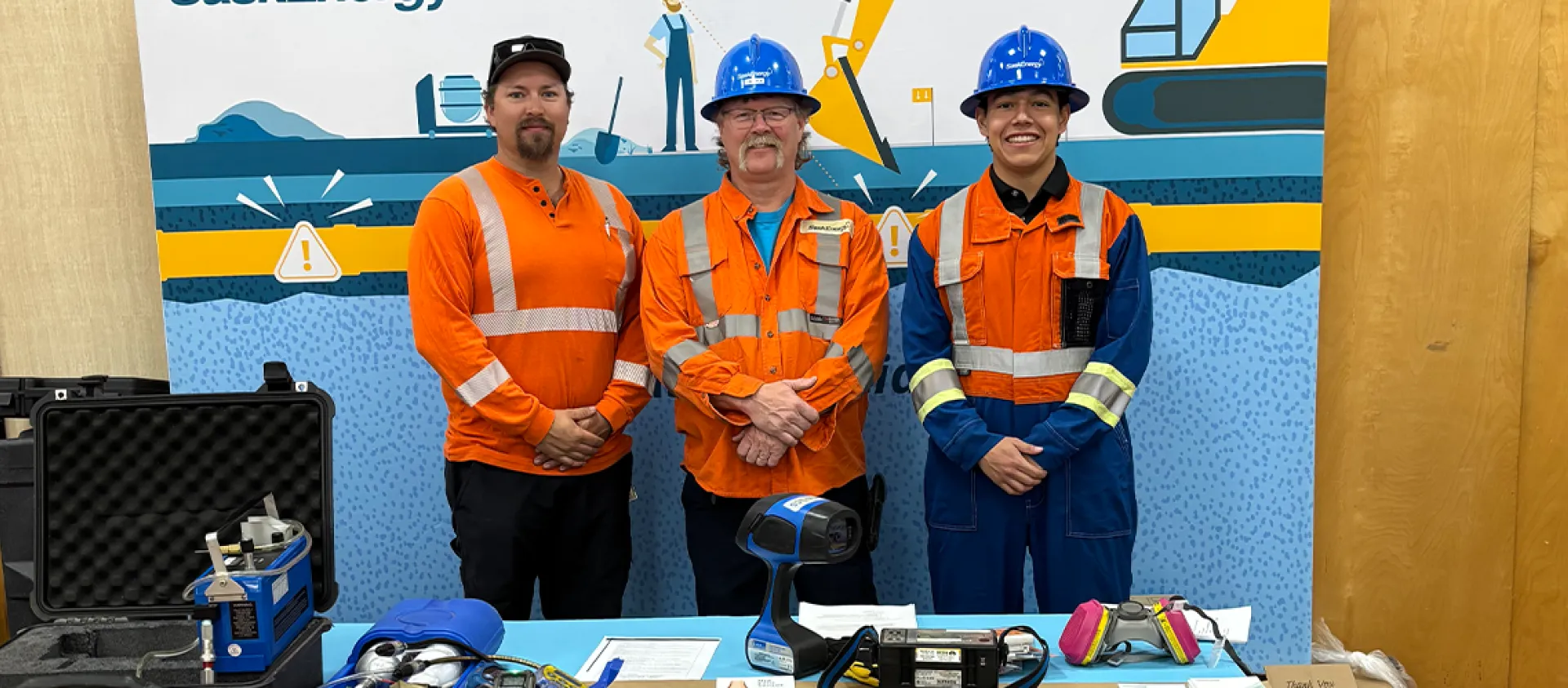 Employees in safety gear posing for a photo