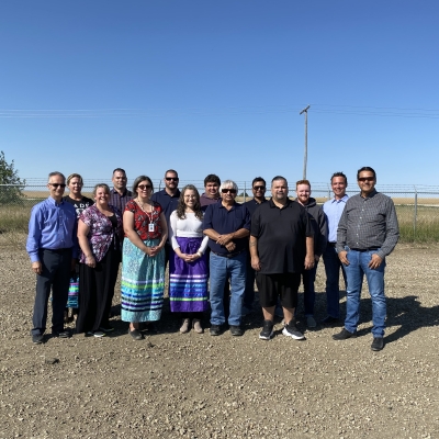 A group of SaskEnergy employees and First Nations members gather for a pipe ceremony.