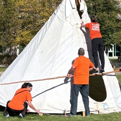 group building a tipi