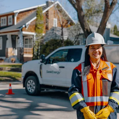 SaskEnergy worker poses in front of SaskEnergy truck
