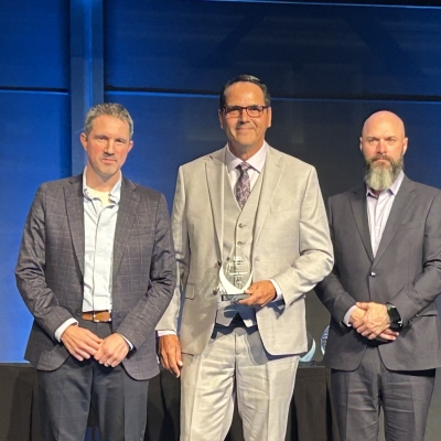 SaskEnergy representative on stage receiving award.