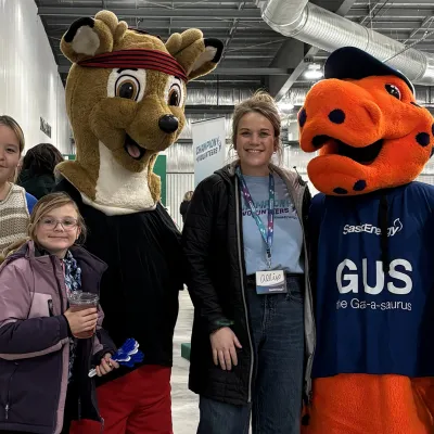 Mascots and people pose for photo