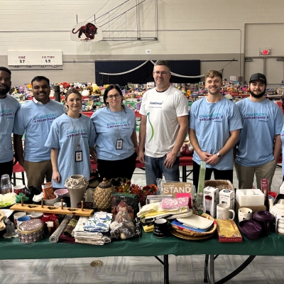 Group photo in front of gifts