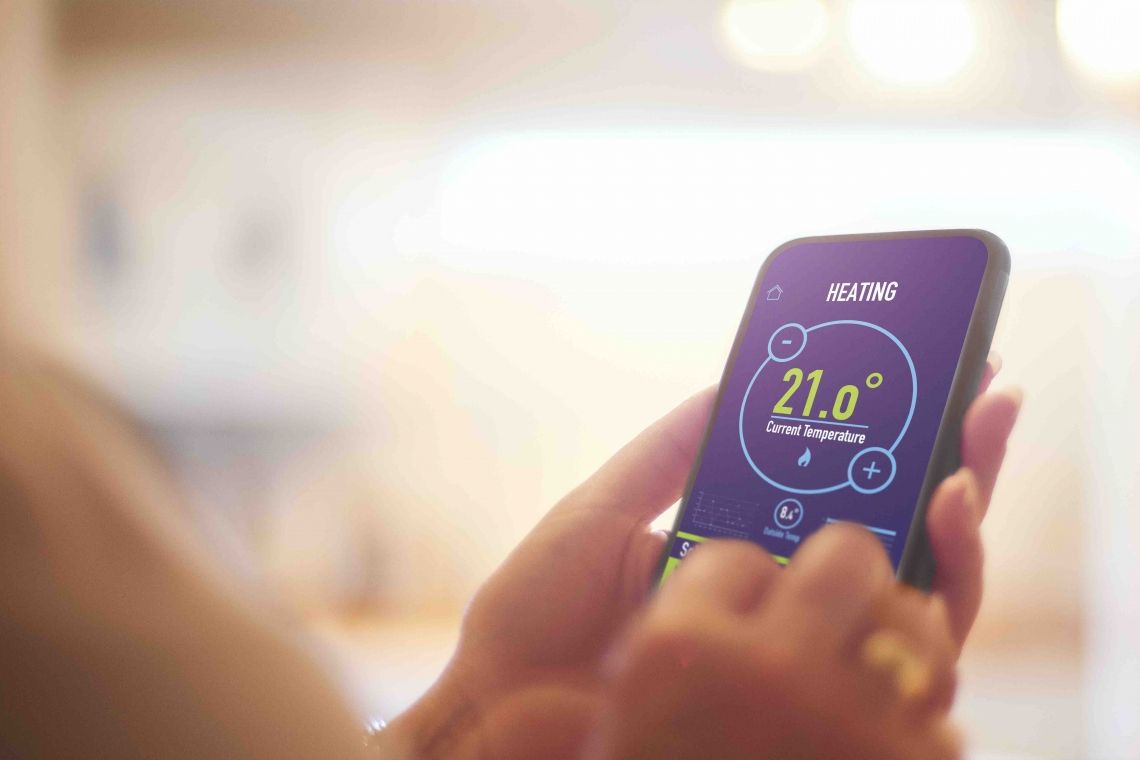 Homeowner using thermostat app