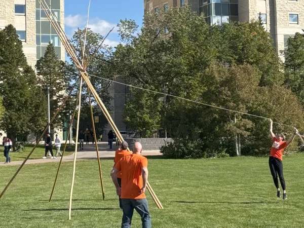Group building a tipi