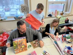 People wrapping gifts