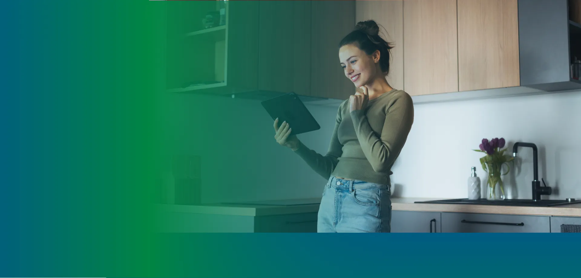 women looking at a tablet in her kitchen