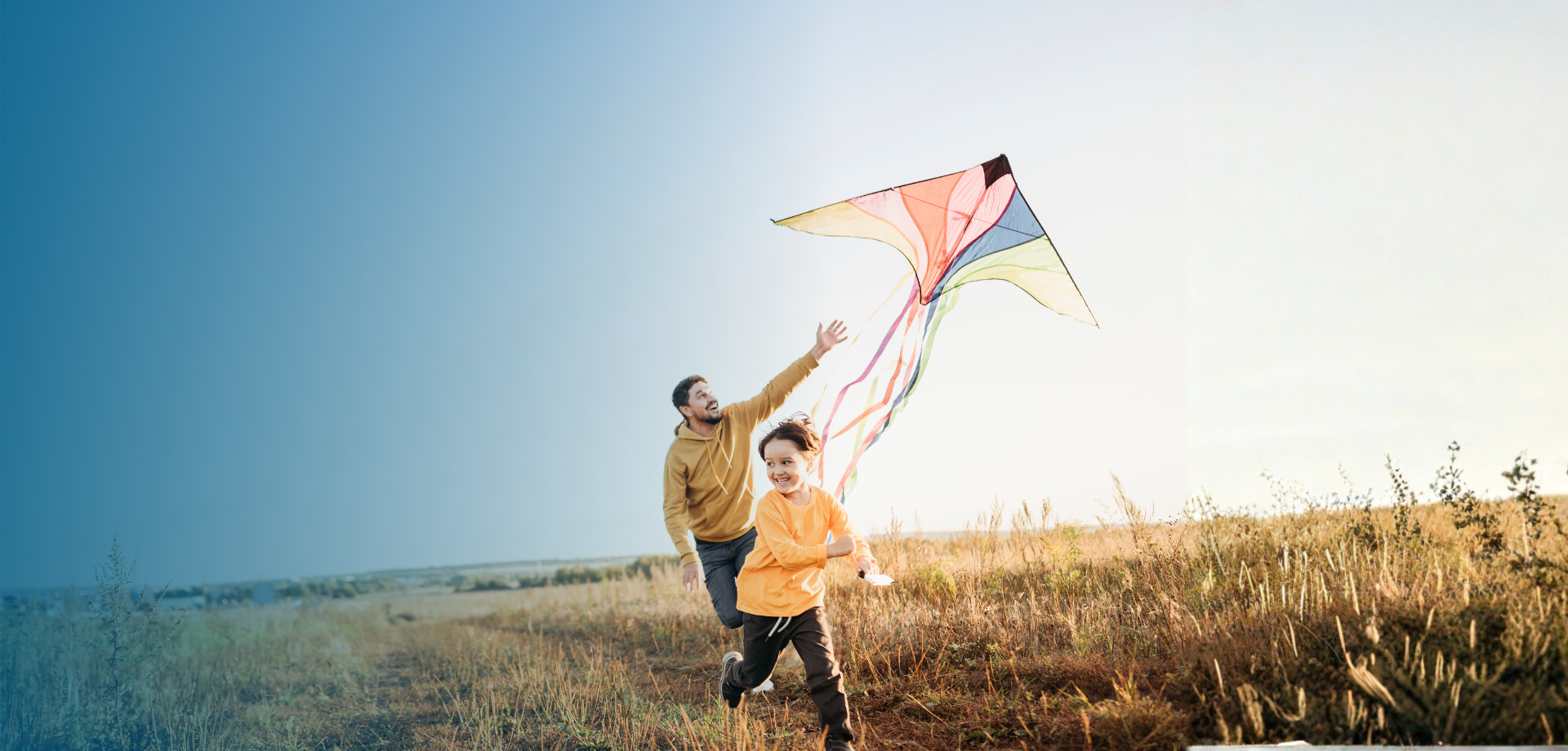 father and son flying a kite in the Fall