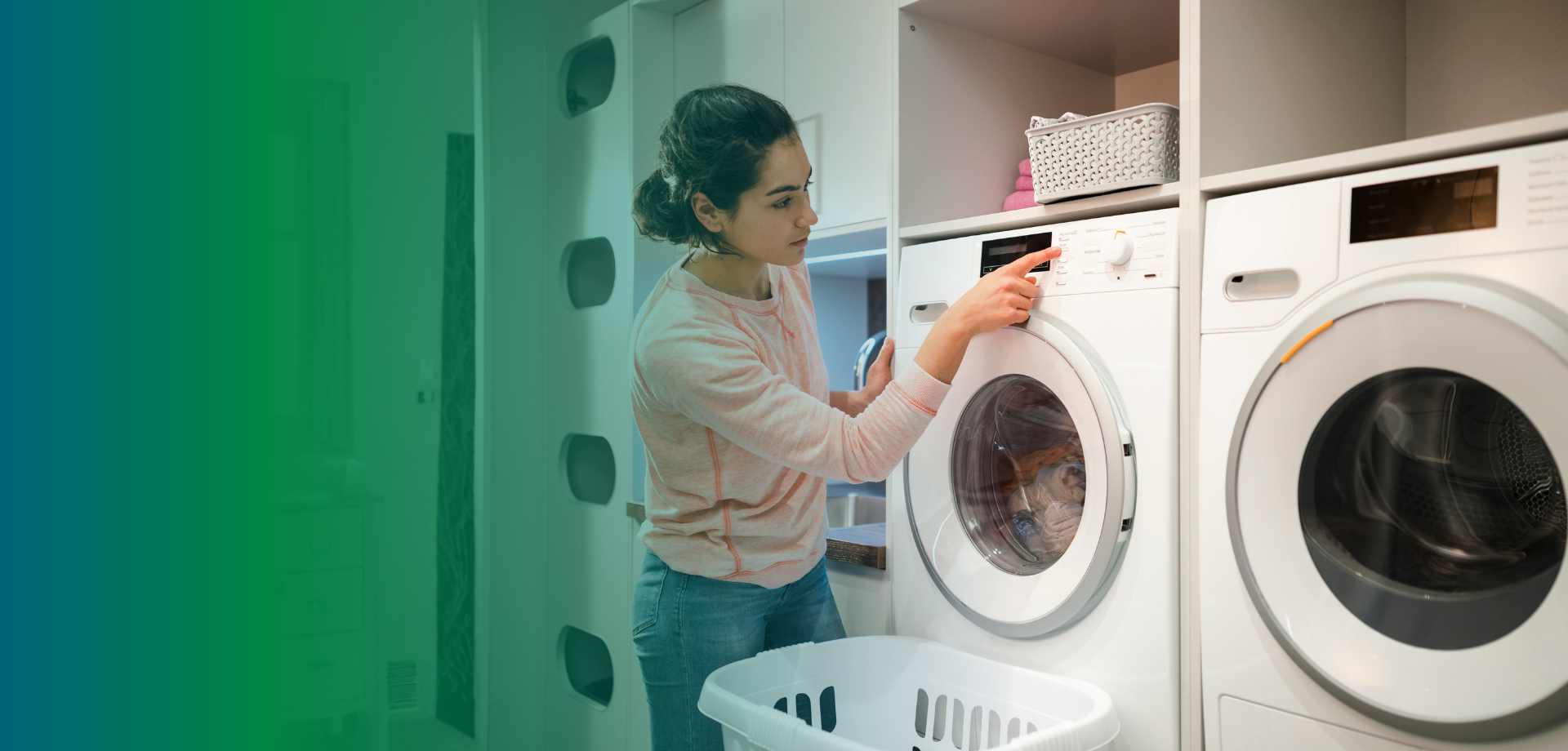 A women pushing a button on her washing machine to promote washing clothes in cold water to reduce energy costs