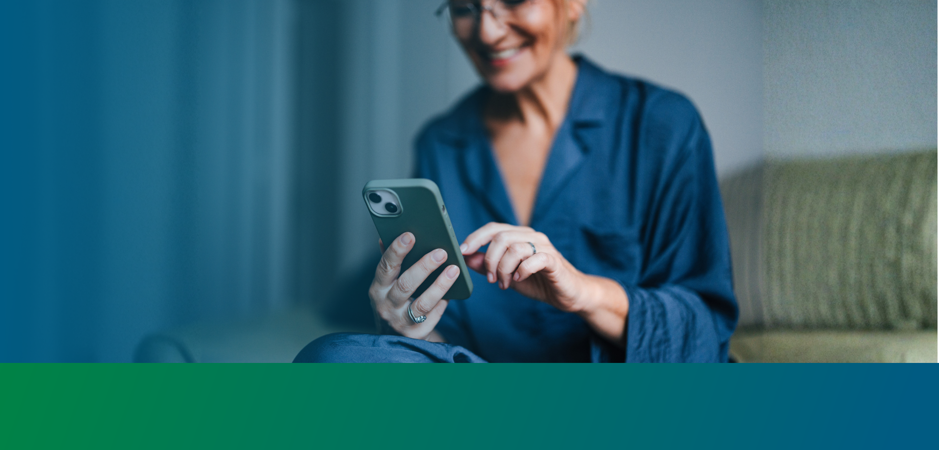 woman looking at phone screen smiling